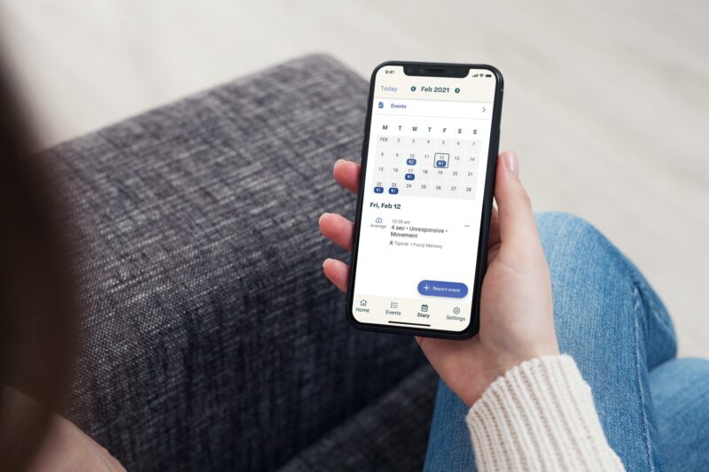 Person holding a phone with Seer App open